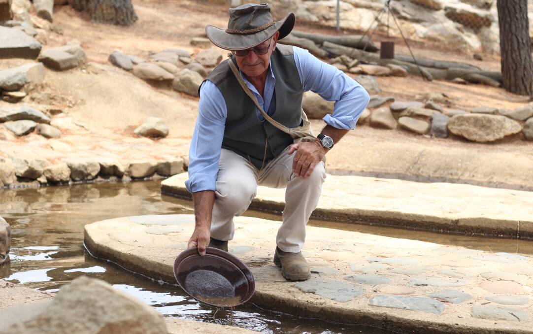 LOOKING FOR GOLD: Bathurst Goldfields head tour guide Garry Pomeroy showing how gold panning is done. Photo: BRADLEY JURD