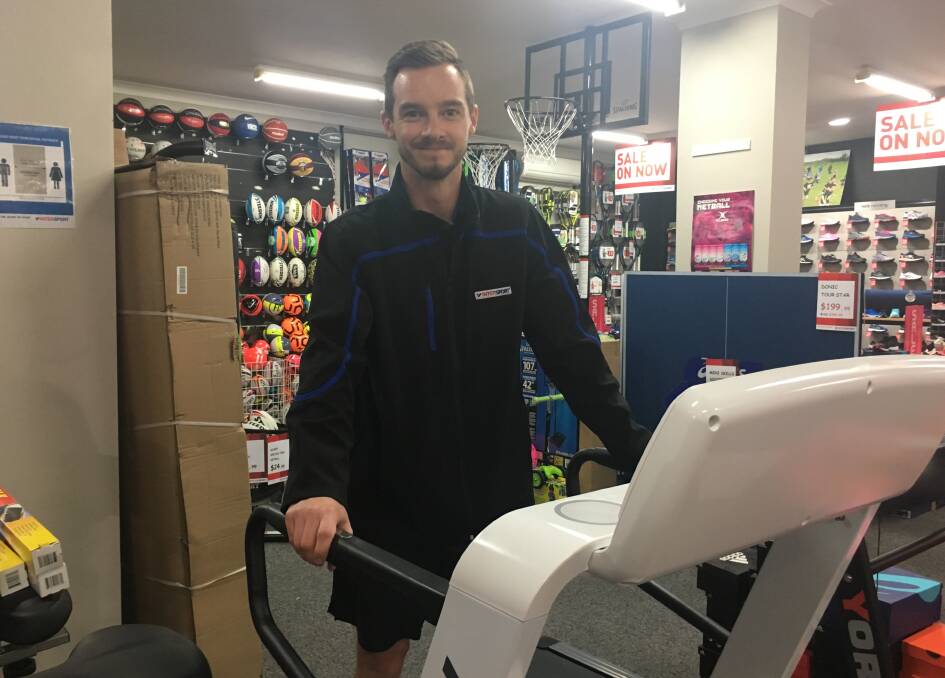 ON SALE: Intersport Bathurst assistant manager Beau Yates says indoor fitness items have been popular. Photo: BRADLEY JURD