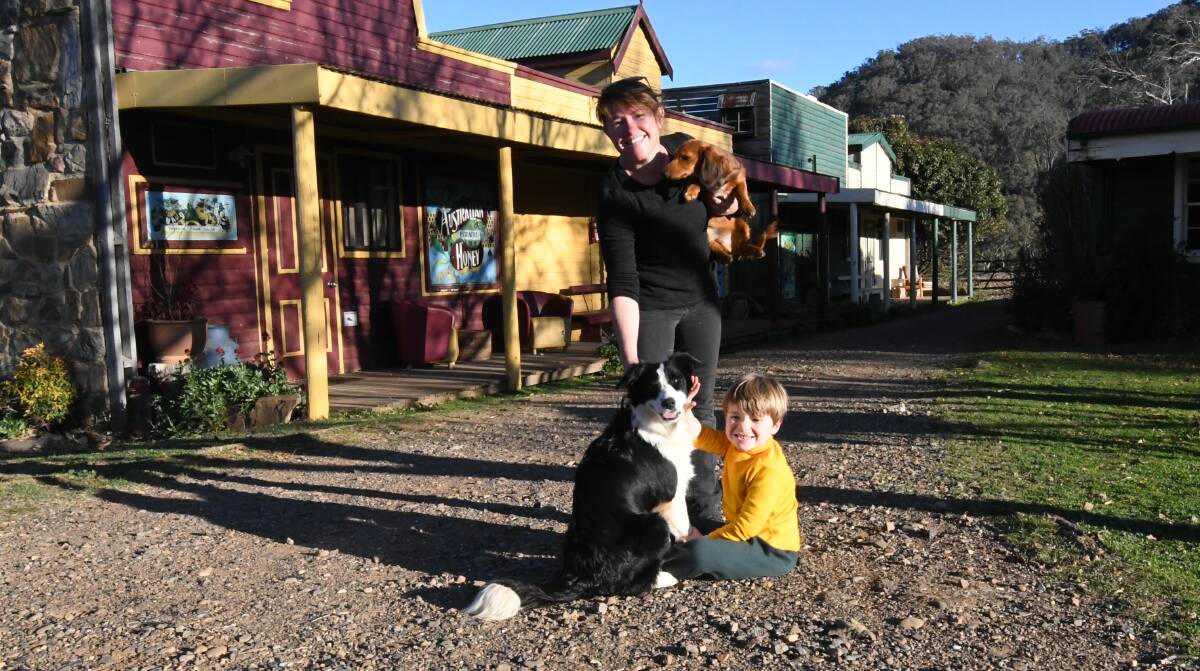 BACK OPEN: Chesleigh manager Sasha Cody holds her miniature dachshund Sizzle, with Border Collie Faith and her son Billy Wafer. 