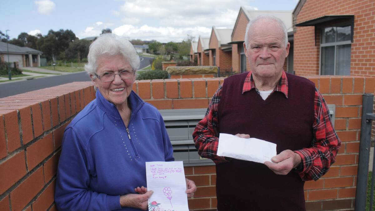 KIND GESTURE: Helen and Graham Moon at their Kelso residence, with the letter they received. Photo: BRADLEY JURD