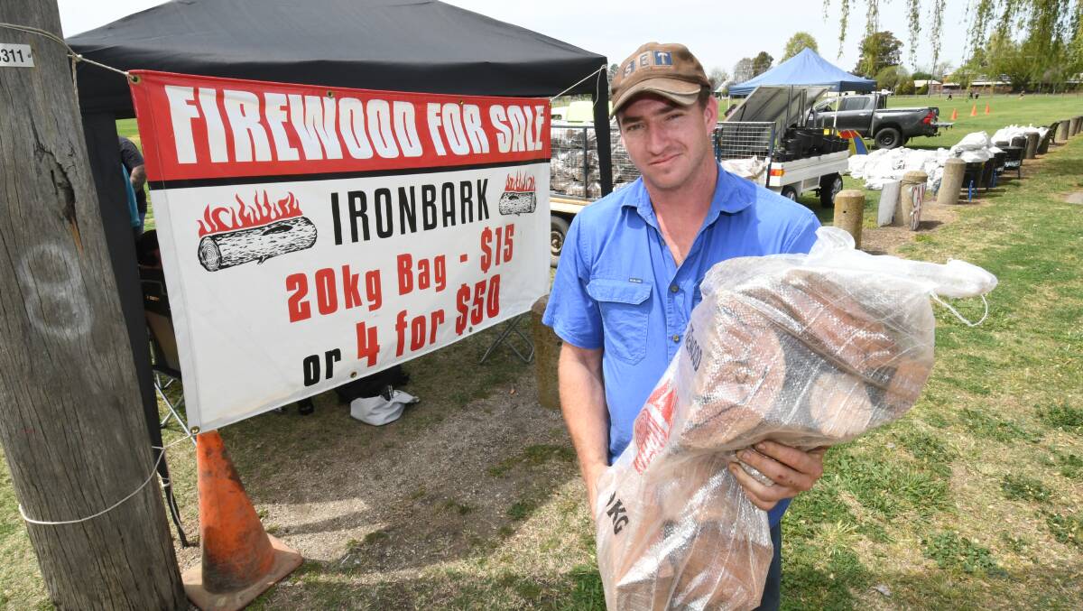 Blake Mobbs from Molong selling ironbark firewood to the Bathurst 1000 campers at Morse Park. Photo: CHRIS SEABROOK 100719cwood2