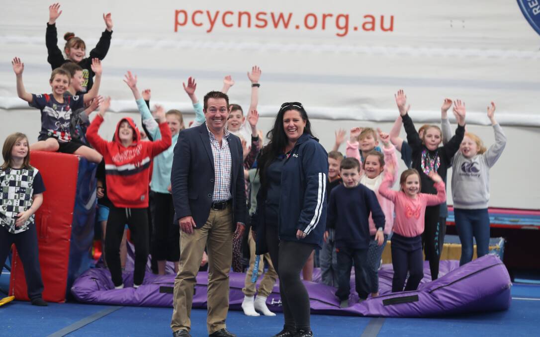 REBATE WIN: Bathurst MP Paul Toole and Bathurst PCYC activities officer Melinda Robinson with children at the centre on Wednesday. Photo: PHIL BLATCH