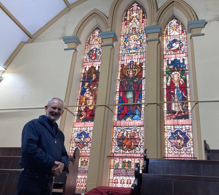 ANNIVERSARY: Bathurst Uniting Church Reverend Keith Hamilton with some of the church's stained-glass windows. Photo: JACINTA CARROLL