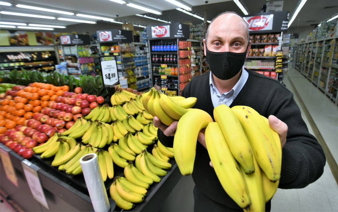 IN DEMAND: IGA Trinity Heights manager Kevin Allen with plenty of fresh produce for sale. Photo: CHRIS SEABROOK 081821cbananas