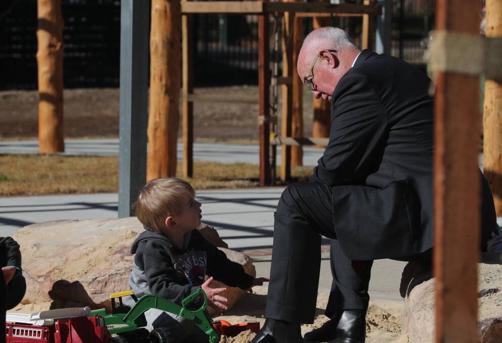 OUTDOOR FUN: Phillip Corner gives Bathurst mayor Graeme Hanger some tips on digging at new outdoor space at the Kelso Community Hub. Photo: BRADLE YJURD