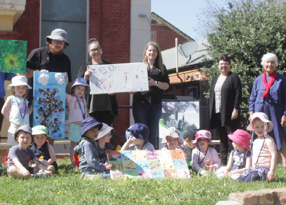 ARTWORK: Children from Scallywags with their artworks, as they prepare to donate them to the Uniting Safe Shelter cafe. Photo: BRADLEY JURD