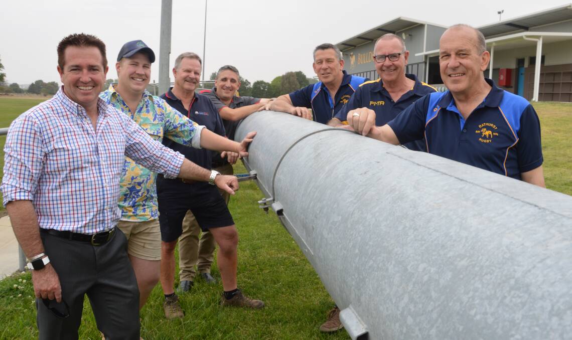 NEW LIGHTS: Member for Bathurst Paul Toole with Bathurst Bulldogs club members ahead of the installation of new lights at Ashwood Park. 
