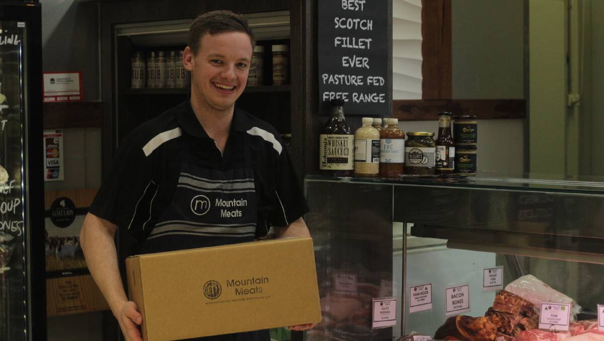 CLICK AND COLLECT: Mountains Meat's Ben Smith with a buy local box, outside the Bathurst City Centre-based butcher. Photo: BRADLEY JURD