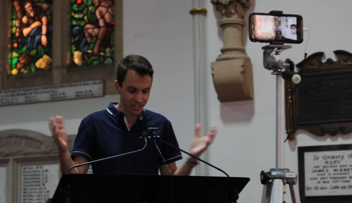 GOING LIVE: Bathurst Presbyterian Church pastor Tristan Merkel speaks as Sunday night's service is streamed live via Facebook. Photo: BRADLEY JURD