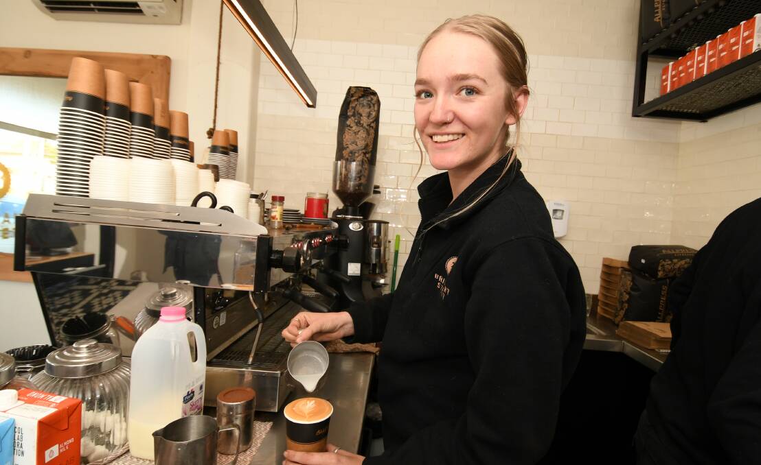 LEADING THE WAY: Brilliant Street Cafe barista Erika Lindsay serves up a coffee on the job. Photo: CHRIS SEABROOK 070720coffee2