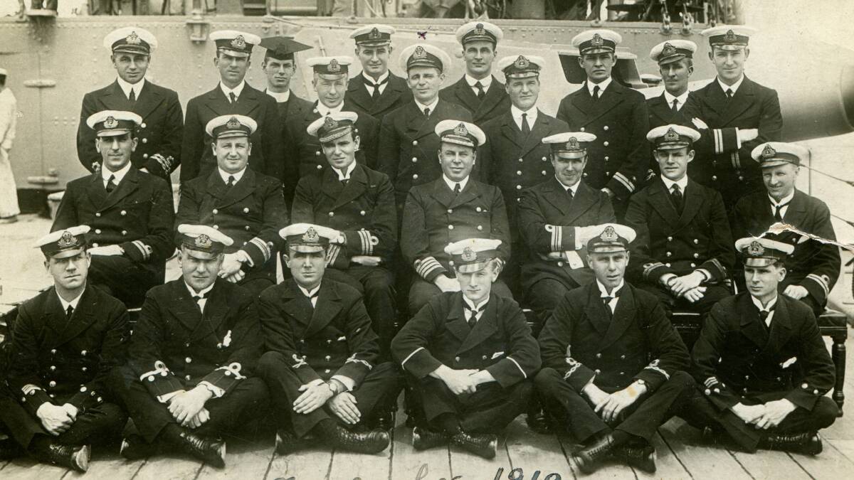 ON DECK: William Fitzsimmons (sixth from the left in the back row) posing for a formal photo on the deck of the light cruiser HMAS Encounter in November 1918.