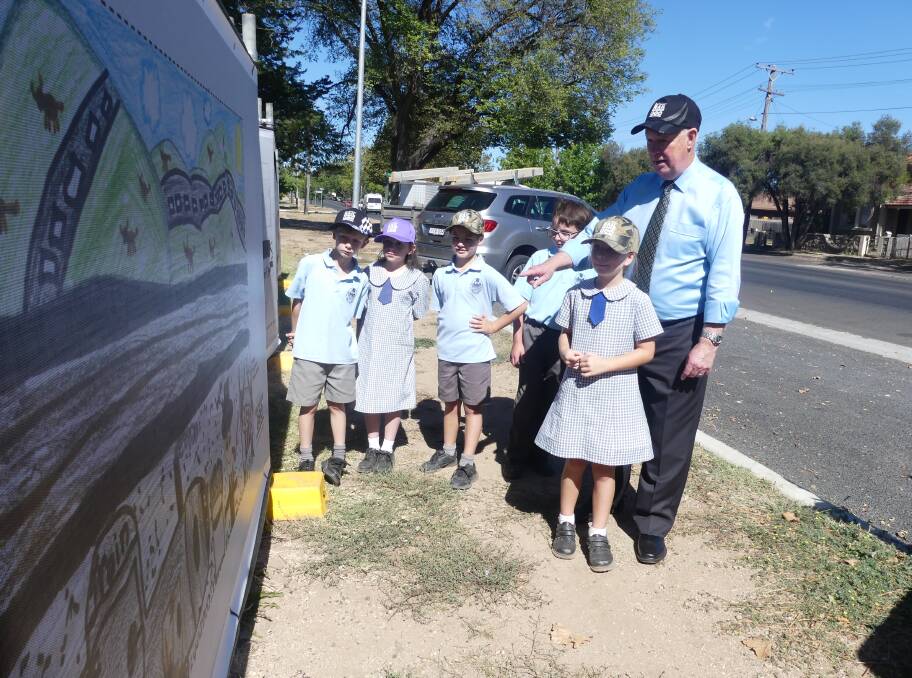 LOOKING GOOD: Mayor Graeme Hanger with Perthville Public School students and their artwork at the site of the Bathurst Rail Museum.