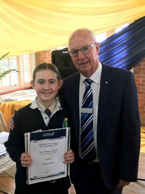 CHRISTMAS ART: Georgina Payne from the Cathedral School with mayor Graeme Hanger. Georgia received a Year 6 Mayor's Award.