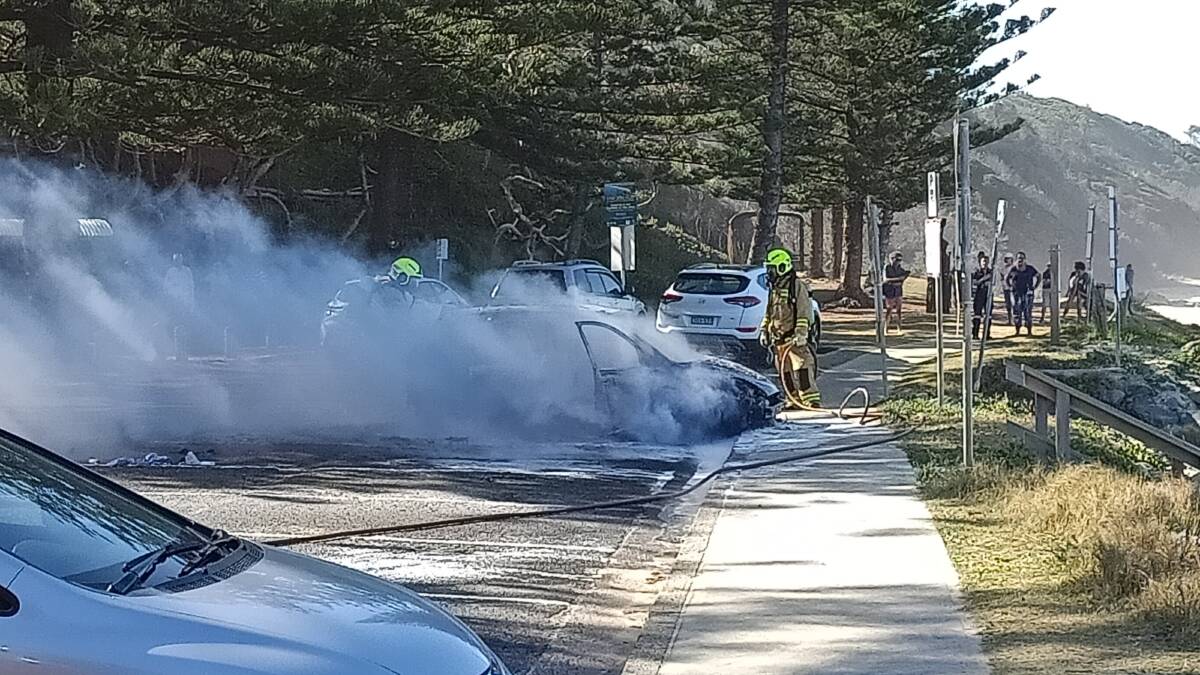 The car was destroyed by fire while in the carpark at Shelly Beach, Port Macquarie. Photo and video courtesy: Steve Drew.