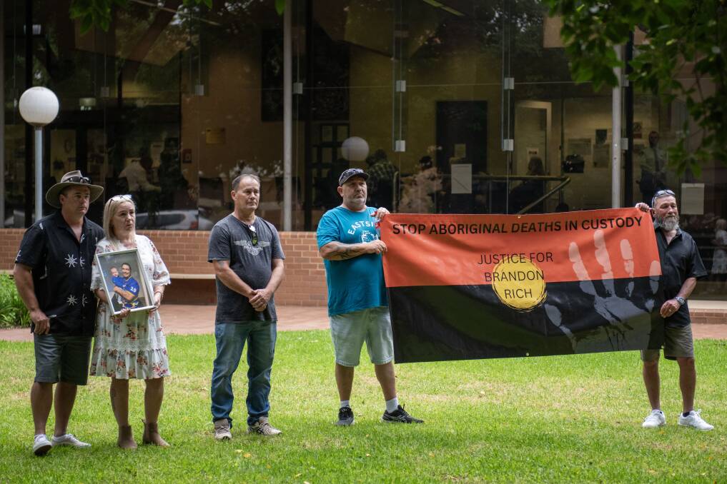 Corina Rich with fiance Troy, holding a photo of Brandon Rich, while other family members hold a banner saying 'Stop Aboriginal deaths in custody' on Monday November 20. Picture by Belinda Soole 