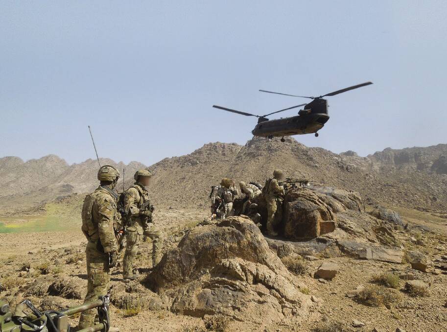 JOINT DEPLOYMENT: Special Operations soldiers after disembarking from a US Army helicopter with their Afghan National Security Force partners in Kandahar province, southern Afghanistan, in 2012. Picture: ADF