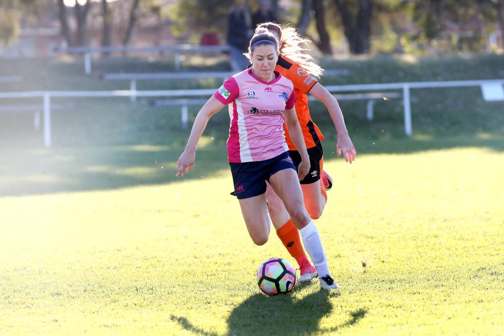 HAPPY IN PINK: Erica Halloway controls possession for the Illawarra Stingrays. Photo: SYLVIA LIBER