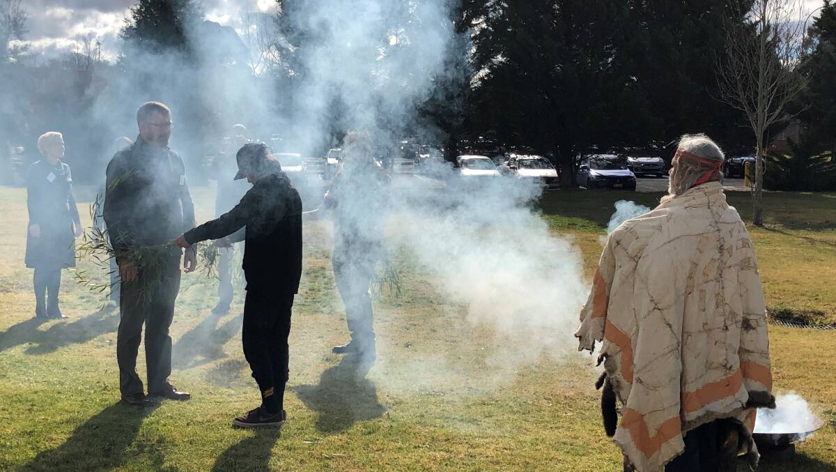 VISITING: Dr Mathew Johnson, executive director of the Swearer Centre for Public Service at Brown University in the United States, is welcomed to Charles Sturt by Bathurst Wiradyuri traditional owners in a smoke ceremony. 