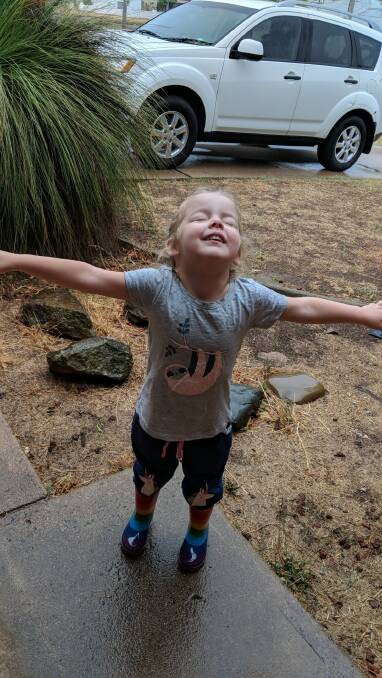 HEAVENS ABOVE: Briellen Lucas took this photo of her daughter Mabel, 3, enjoying the rain in Bathurst last week. Photo: SUPPLIED