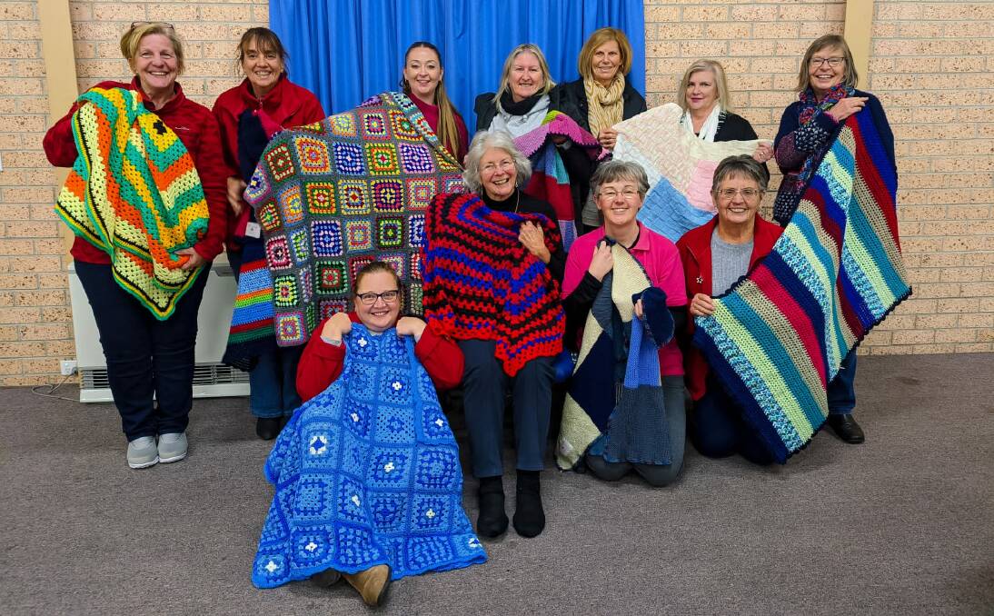 RUGGED UP: Bathurst Panorama Chorus members (back) Anne Bestwick, Fiona Harris, Kylie Taylor, Karen Burgoyne, Betty Murphy, Anne Patteson and Anne Young and (front) Jenny Seager, Christine Hurford, Beth Pratley and Yvonne Pro with some of the blankets recently donated to Ronald McDonald House Orange.
