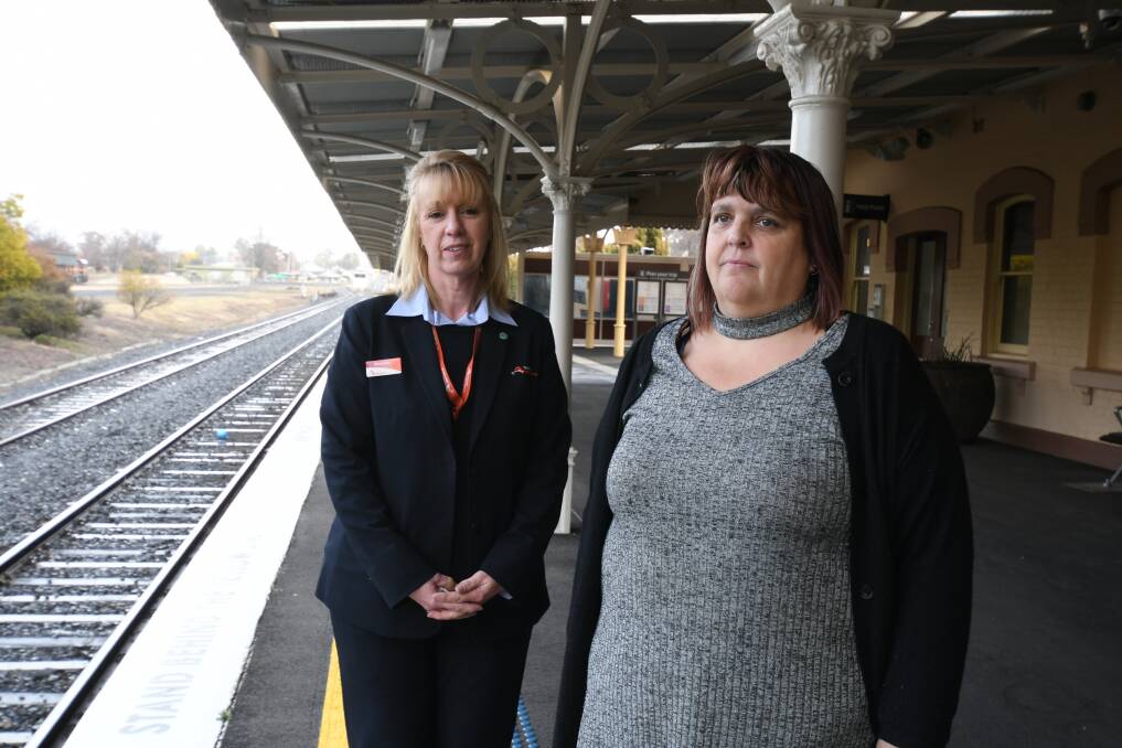 GOOD WORK: Margaret Kennedy, a senior customer attendant with passenger Debbie Osborne at Orange station. Photo: JUDE KEOGH 0720jktrain1