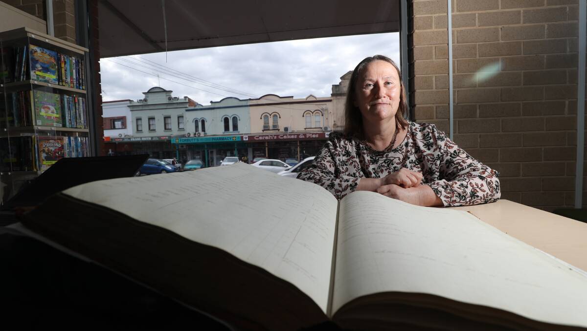 BOOK IT IN: Wendy Gallagher from State Archives and Records with a volume from the 1828 Census at Bathurst Library. Photo: PHIL BLATCH