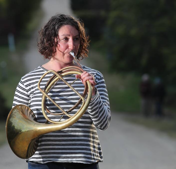 RIGHT NOTE: Carla Blackwood, a French horn tutor at the Conservatorium of Melbourne, plays the Last Post in Stewart Street, Evans Plains. The Cooee March of 1915 stopped at Evans Plains overnight before marching into Bathurst. Photo: PHIL BLATCH