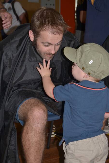 HAIR TODAY: Teacher Nathan Kenny's son was interested to know where his dad's beard had gone during the World’s Greatest Shave event at Bathurst High on Friday.