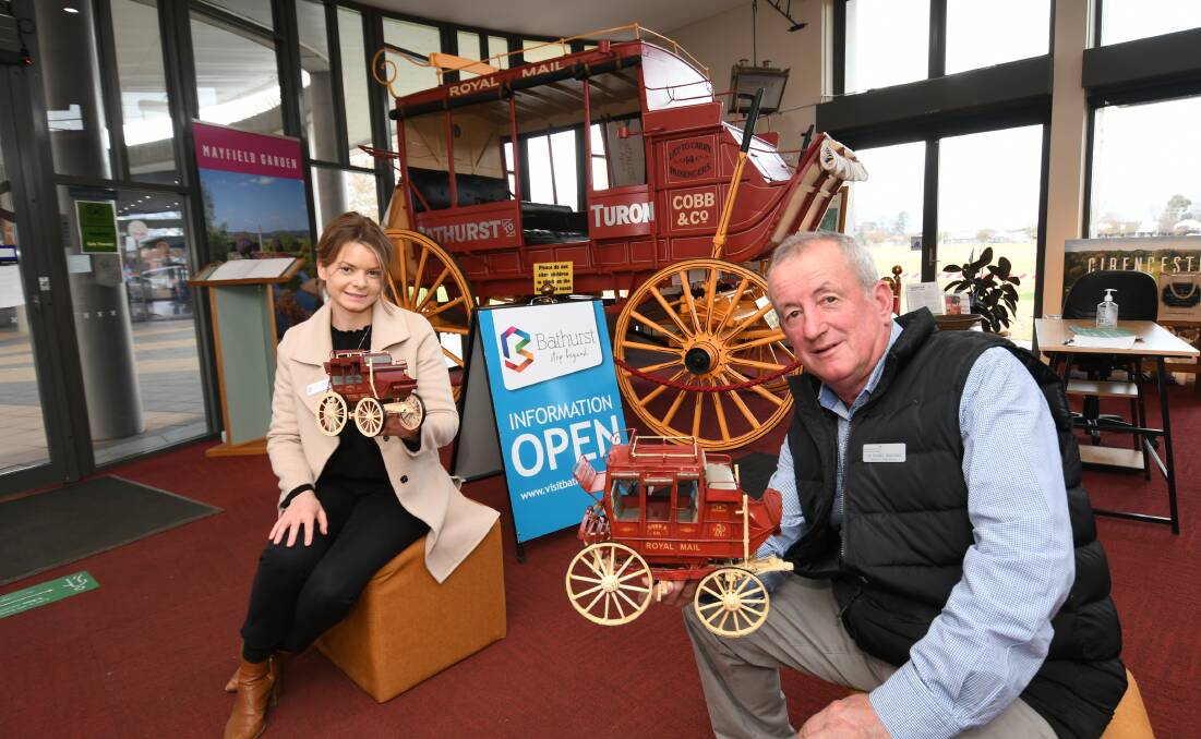 POSITIVE: Bathurst Visitor Information Centre staff member Phoebe Rhodes and mayor Bobby Bourke holding metal stagecoach models for sale at the centre. Photo: CHRIS SEABROOK 061020tourism1