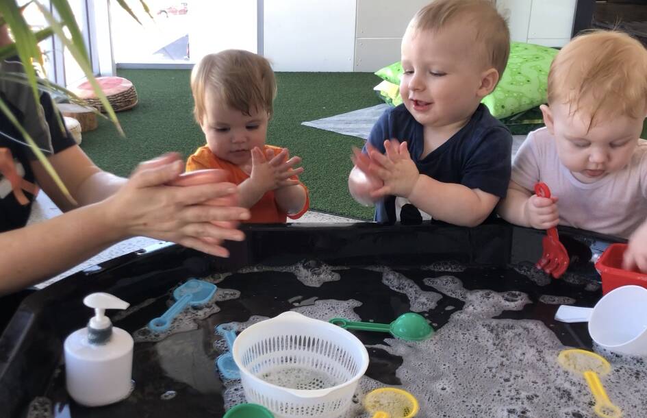 GIVE ME A HAND: Children Georgia, Cash and Kaylee practise washing their hands at Balance Early Education.