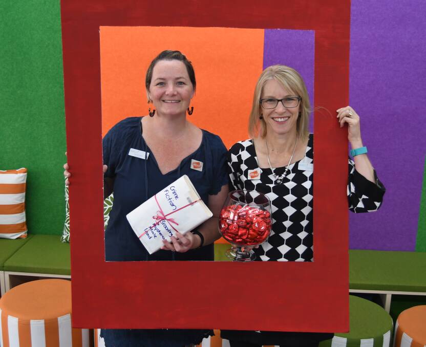 SMILE: Rhiannon Mijovic and Tracey Platt are inviting locals to be part of Library Lovers' Day at Bathurst Library, where there will be a photo booth, among other activities.