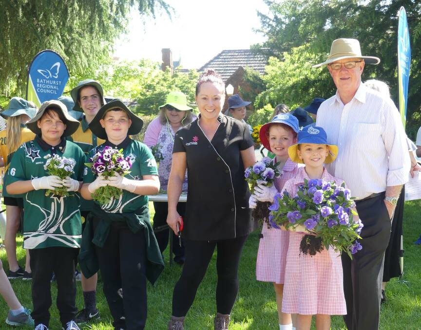 BLOOMING LOVELY: Mayor Graeme Hanger with Vanessa Pringle and some school-children and flowers from Kings Parade.