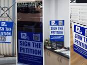 The hospital car parking petition signs are in various businesses around town. Pictures supplied.