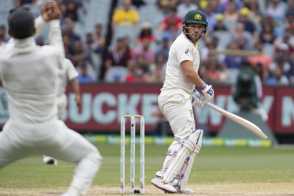 BAD LOOK: Aaron Finch bats looks back before being caught on day four of the third cricket Test between India and Australia in Melbourne. Photo: AP PHOTO/ASANKA BRENDON RATNAYAKE