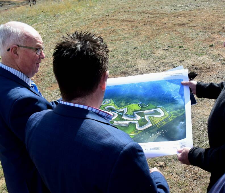 THE ONE: Mayor Graeme Hanger and Member for Bathurst Paul Toole look at the concept design for the new track. Photo: RACHEL CHAMBERLAIN 071918rctrack2