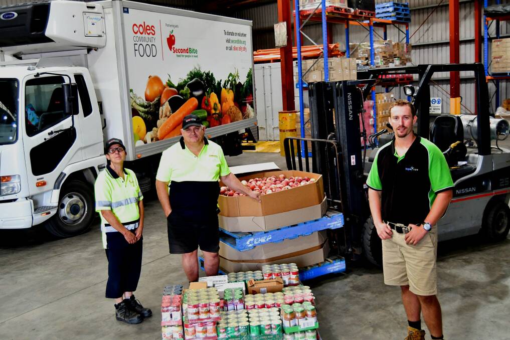 WORKING TOGETHER: SecondBite warehouse worker Sonya Burke and truck driver Michael Burke, with HopeCare's operations and welfare services manager Elliot Redwin. Photo: RACHEL CHAMBERLAIN 021221rcfood