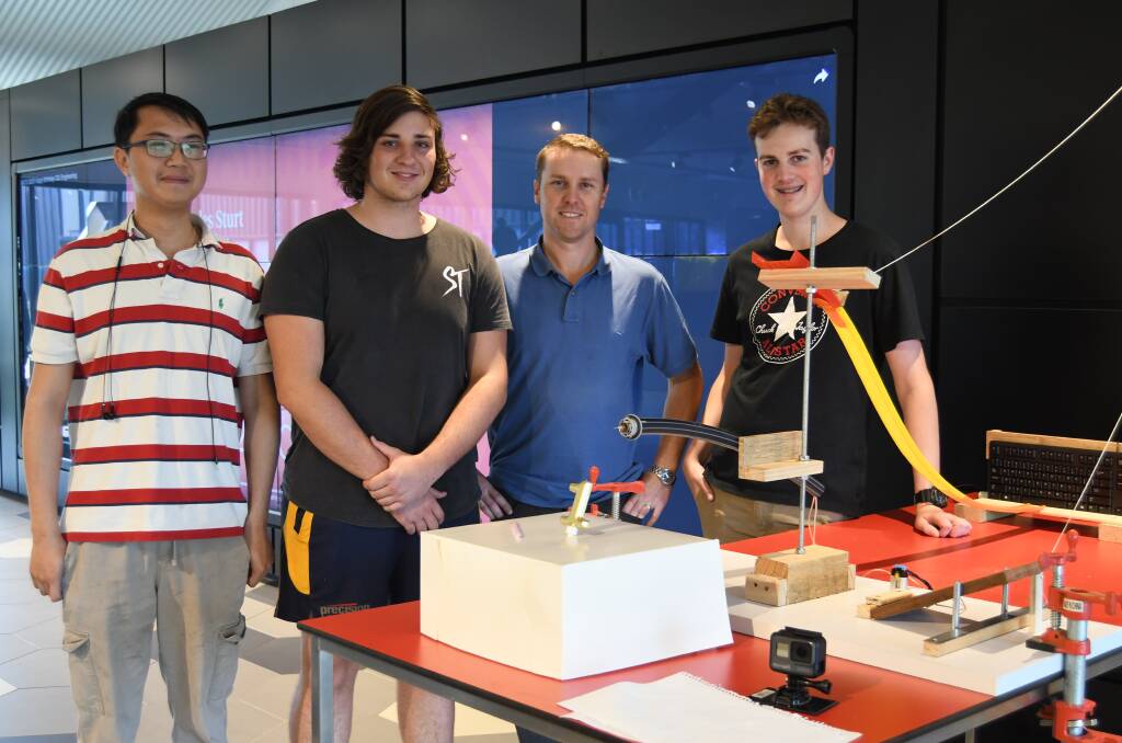 STEP BY STEP: Charly Yeh, Kolby McMahon, Ryan Marr and Reid Noyes with part of their section of the latest Charles Sturt University engineering Rube Goldberg Machine.