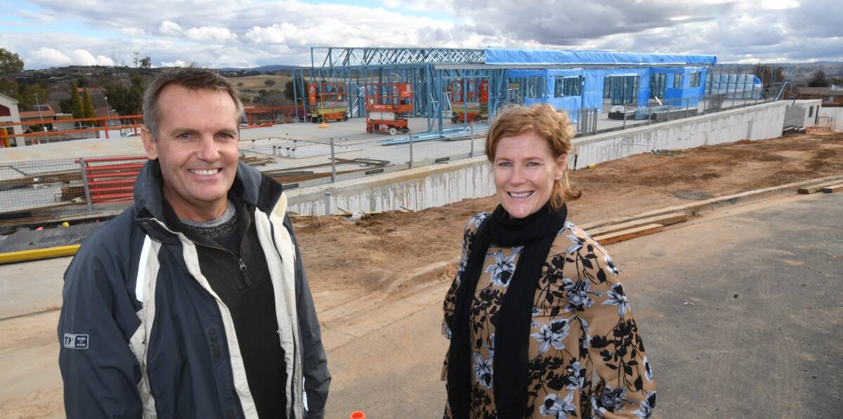 GOING UP: Andrew and Darlene Wadham with their childcare centre under construction behind them. Photo: CHRIS SEABROOK 061318childcr1