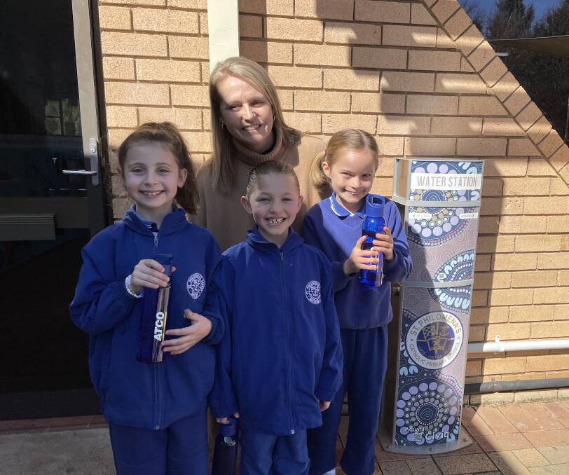ATCO communications and engagement manager Kimbalee Clews with St Philomena's students and one of the new filtered water stations.