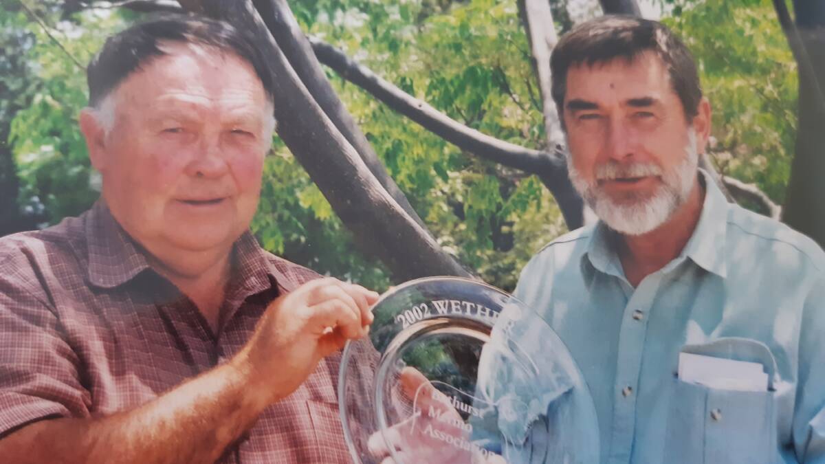 LOOKING BACK: A flashback to a Bathurst Merino Association wether trial at Duramana in the mid-1990s. President Col Ferguson presents a trophy to Lyndhurst breeder Peter Arden.