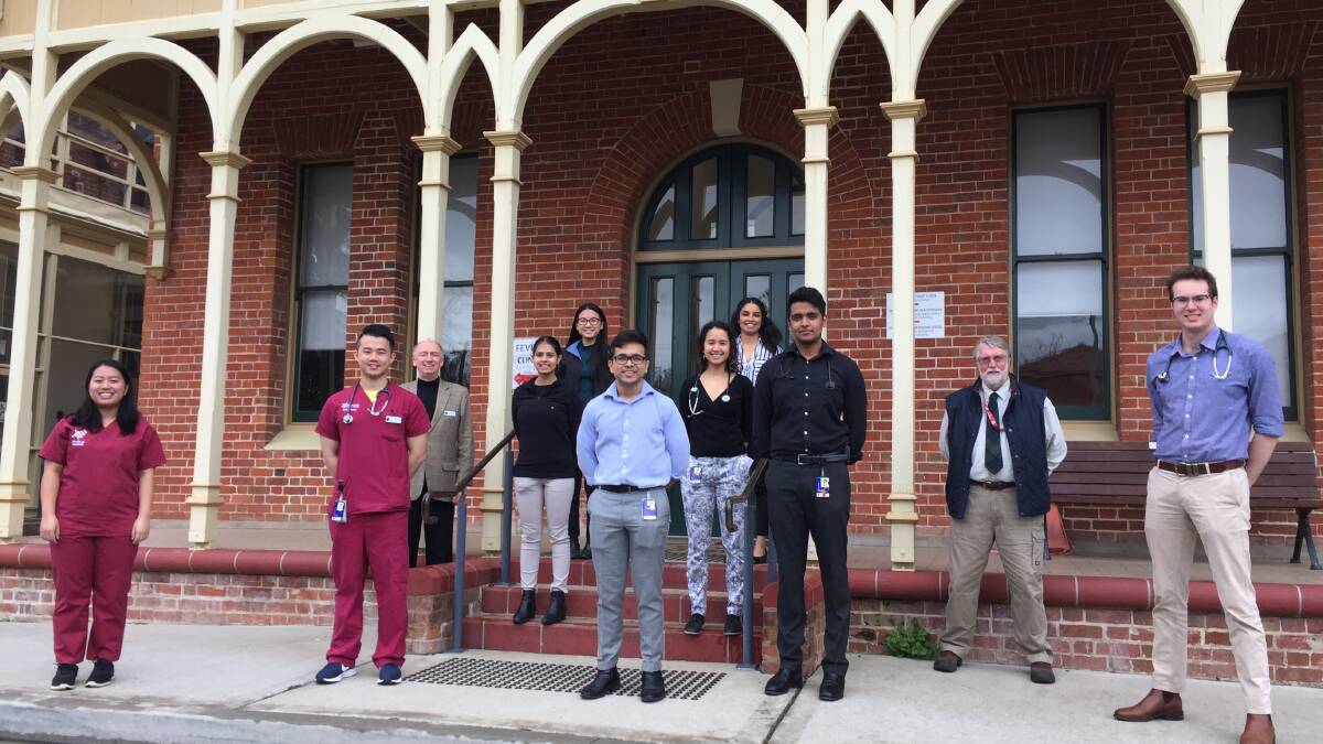 HERE TO HELP: Dr Denis Smith (third from left), Dr Ross Wilson (second from right), Matthew Bojanic (right) and Western Sydney University students.