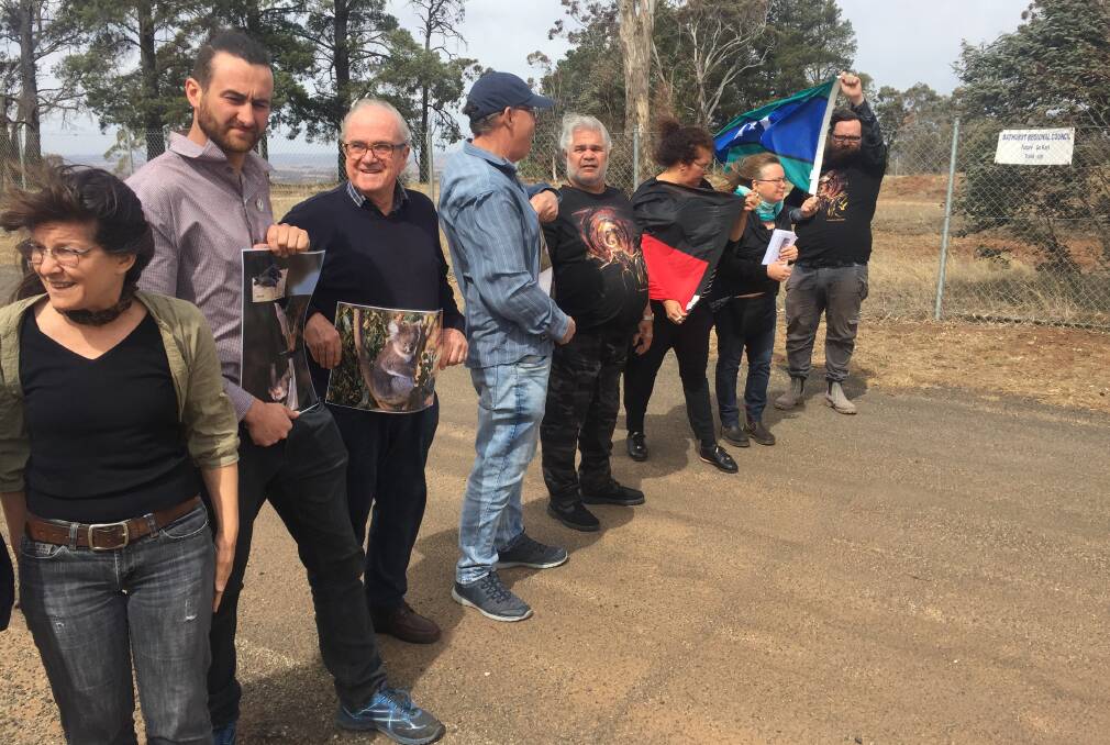 ALL TOGETHER: Citizens and organisations opposed to the site for the new go kart track protesting at the top of Mount Panorama.
