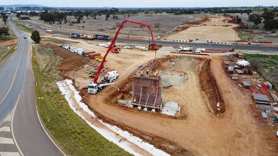 A concrete pour at a new bridge being constructed over rail lines for the Parkes bypass project. Picture from Transport for NSW