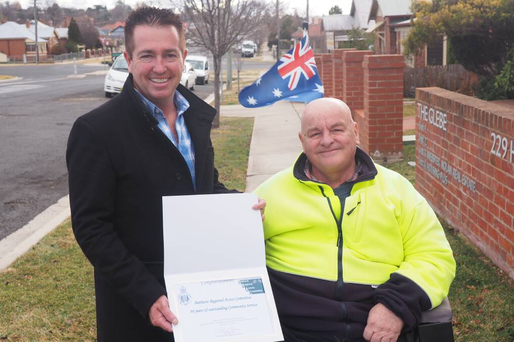 GRATEFUL: Member for Bathurst Paul Toole presents a certificate of appreciation to Bob Triming from the Bathurst Regional Access Committee to mark the committee's 30 years of service to the community.
