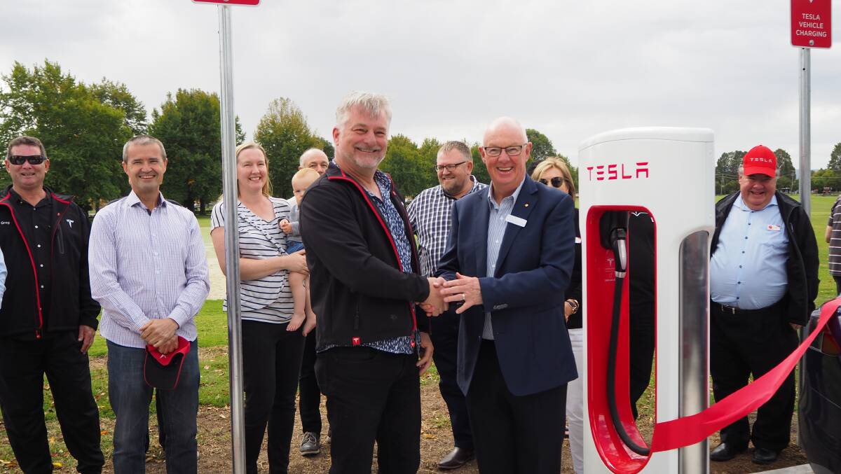 ELECTRIC AVENUE: Tesla Owners Club of Australia president Mark Tipping and mayor Graeme Hanger at the opening of Bathurst's first permanent Tesla Supercharger station in April. Photo: SAM BOLT 040919sbtesl1
