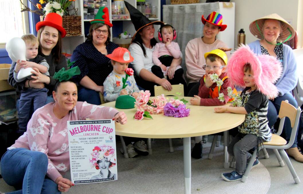 Parents and children from the free BECIS PlayConnect playgroup wearing hats in preparation for an upcoming fundraising Melbourne Cup luncheon. 