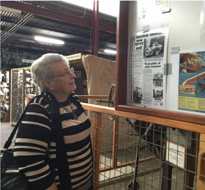 LOOKING BACK: Leslie Stapleton reading about her uncle Eddie’s self-propelling orchard sprayer and her cousin Matthew in the Trevor Pascoe Pavilion at Millthorpe's Golden Memories Museum.