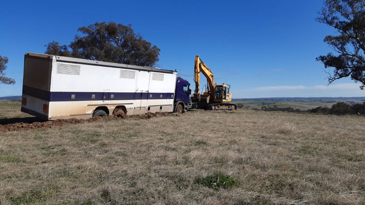 UP AND AT THEM: Hothams' excavator rescued this badly bogged horse transport at Cow Flat.