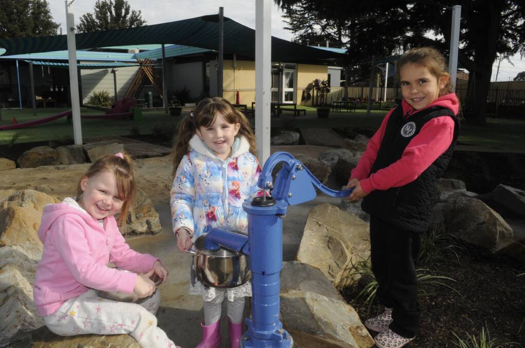 PUMP ACTION: Ellie Hall, Amelia Toohey and Kiah Kennedy, all 5, in Goodstart Early Learning Bathurst's outdoor area. Photo: CHRIS SEABROOK 071717ckids1