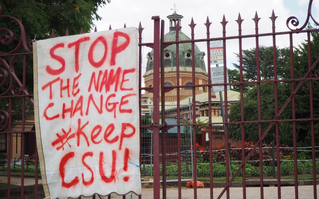 SIGN OF THE TIMES: Opposition to CSU's name change was obvious in Machattie Park on Wednesday afternoon.